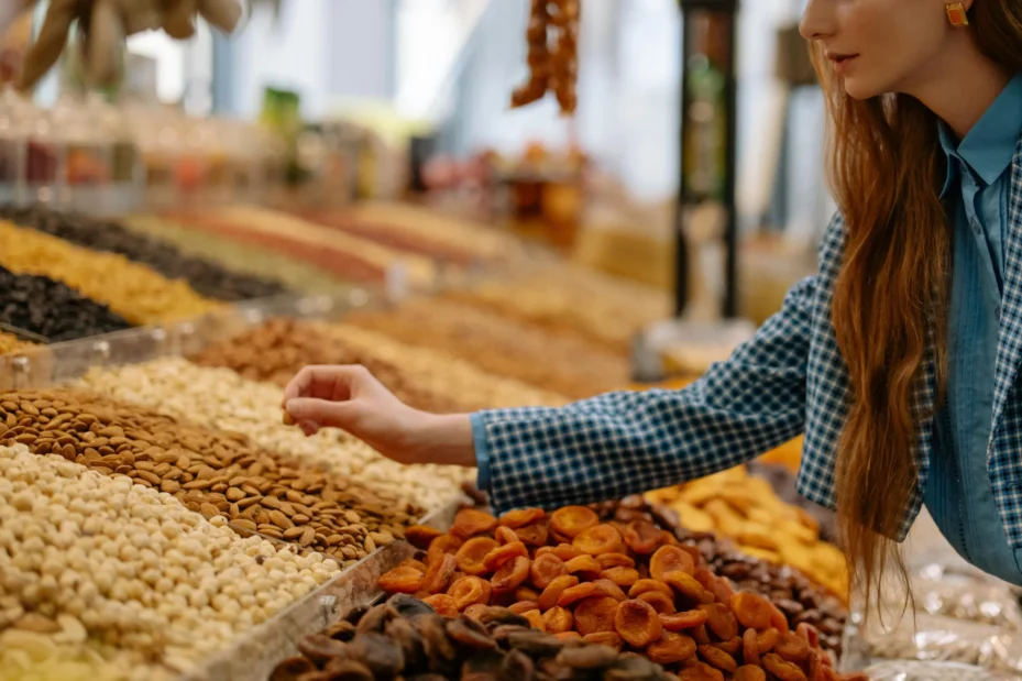 A picture of a person shopping a selection of dried nuts and fruits