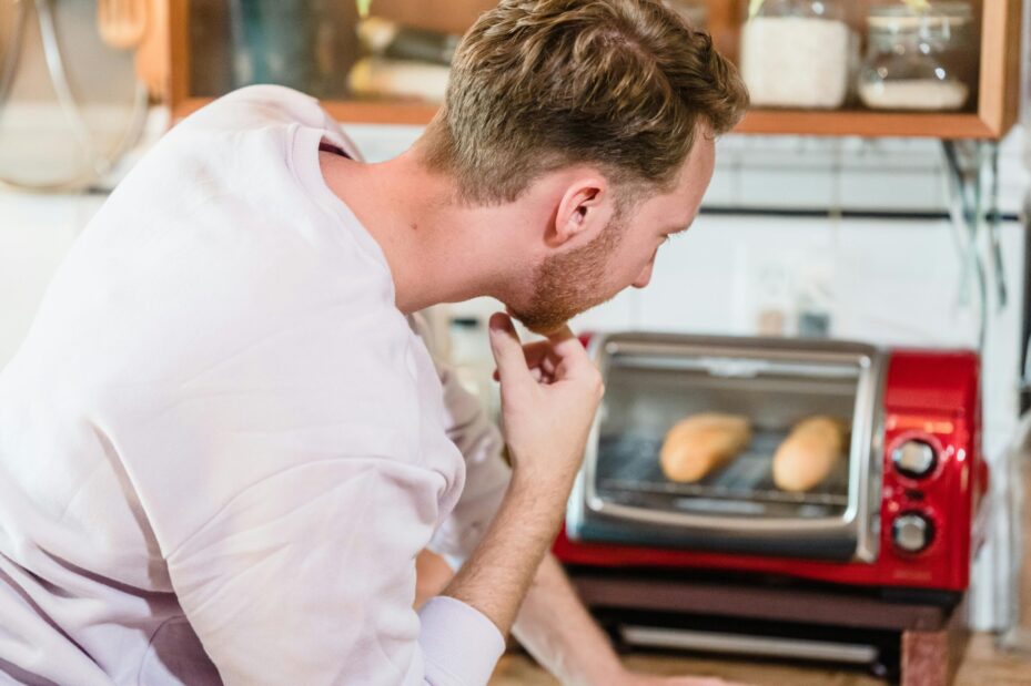 A person looking at a toaster oven.